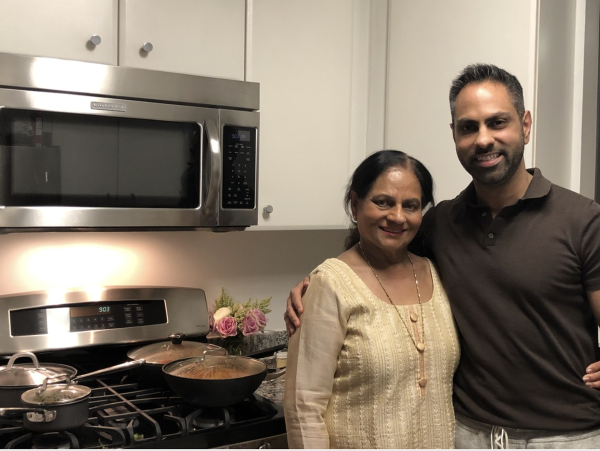 Ramit and his mom in her kitchen, with pots on the stove
